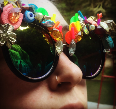 Picture - Model looks at Ithaca Gorges in Smiley Art Goods  Rainbow Sunglasses - Link to Lucky You Eyewear - Vintage Charms and Rainbow Mirrored Sunglasses