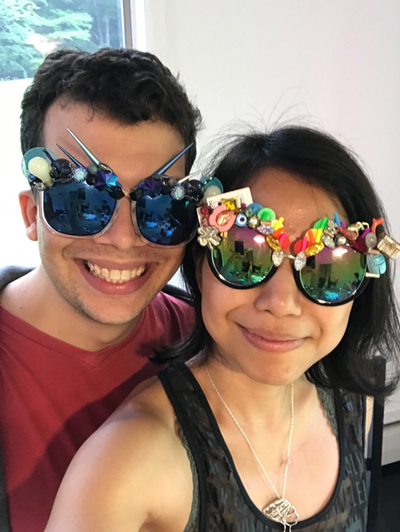 Picture - Couple in mirrored sunglasses from Smiley Art Goods  - Blue spike sunglasses and lucky rainbow sunglasses