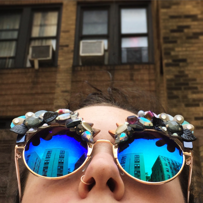 Picture - Model looks up in metallic mirrored sunglasses from Smiley Art Goods - Spiked Floral Sunglasses - Link to Reorders