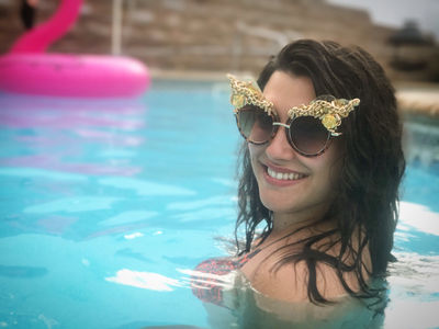 Picture - Model in pool in Smiley Art Goods  Gold Sunglasses - Link to Dripping in Gold Eyewear