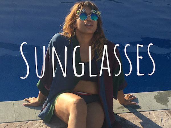 Picture - Model lounging by pool in Smiley Art Goods Eyewear - Link to Sunglasses Shop